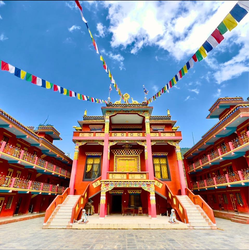 Dzogchen Monastery with colourful prayer flags and traditional Tibetan architecture
